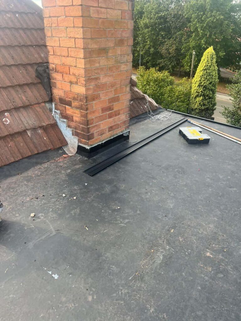 This is a photo of a flat roof which has just been repaired, there is also a chimney stack and some leadwork has also been dressed. Works carried out by TRP Roofing Kirk Ella